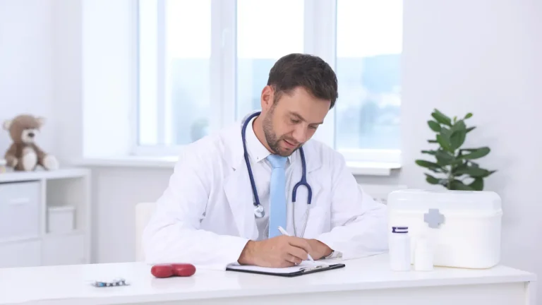 Healthcare provider reviewing revenue cycle documentation at a clinical desk illustrating RCM administrative challenges facing US hospitals in 2026.