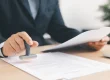 Healthcare professional reviewing and stamping prior authorization documents
