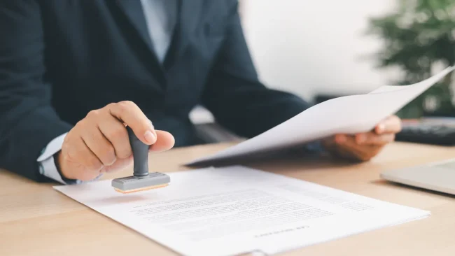 prior authorization Healthcare professional reviewing and stamping prior authorization documents