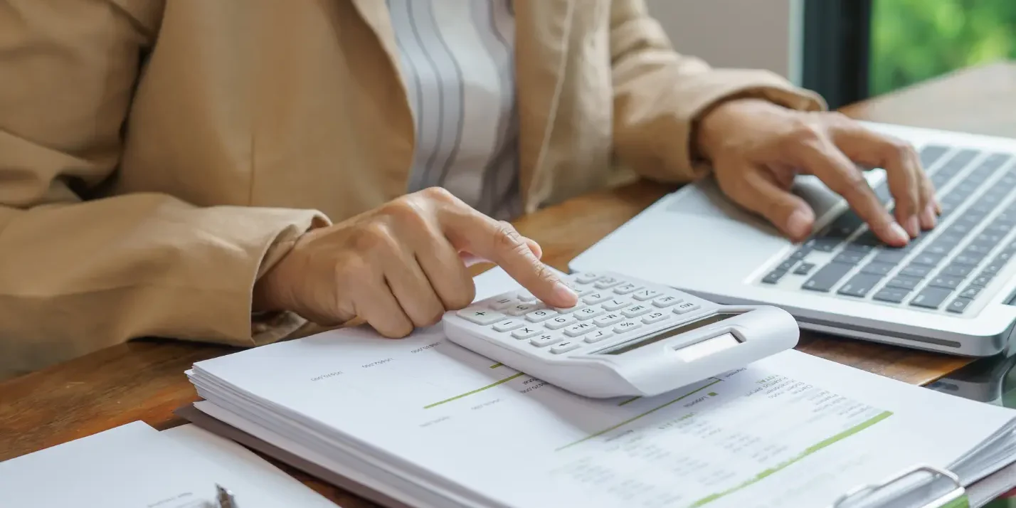 F and a UK business owner managing HMRC tax accounts on laptop